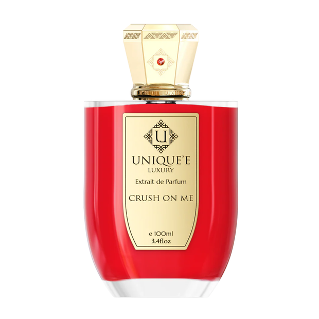 Red perfume bottle with gold cap and label on a white background