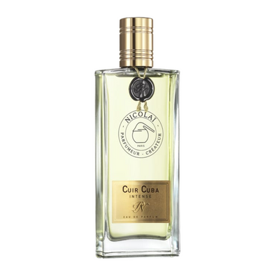 A bottle of Cuir Cuba Intense perfume with a clear glass enclosure and a gold-colored cap, labeled with the brand and product name.