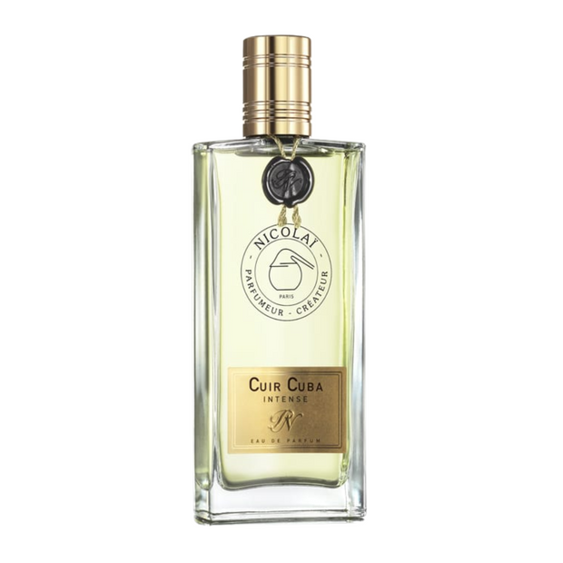 A bottle of Cuir Cuba Intense perfume with a clear glass enclosure and a gold-colored cap, labeled with the brand and product name.