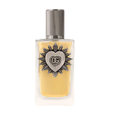 A bottle of Devotion Pour Homme cologne by Dolce&Gabbana, featuring a clear glass container with a yellowish liquid and a decorative metal cap.