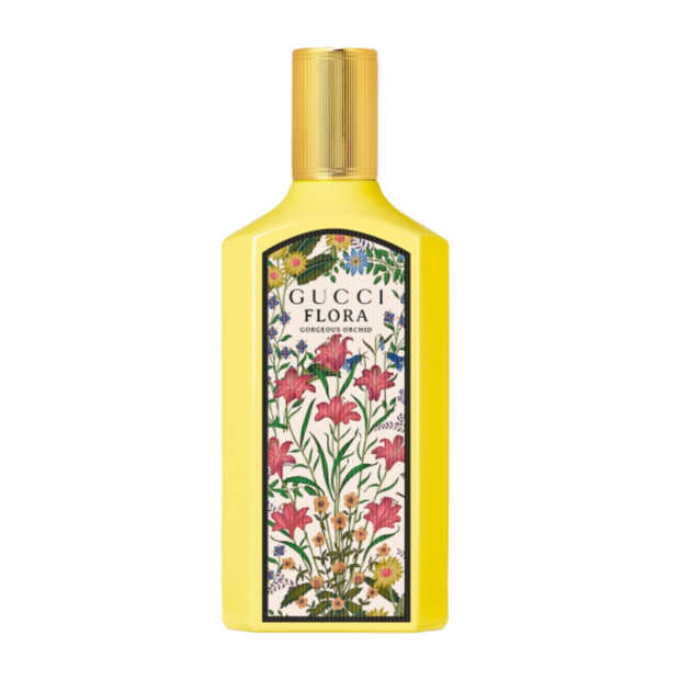 A yellow bottle of Gucci Flora Gorgeous Orchid perfume with a floral design on the label.