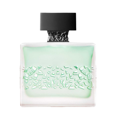 A bottle of GNTONIC M.Micallef perfume with a greenish tint and black cap.