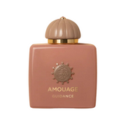 A square-shaped perfume bottle with a beige tint and gold detailing. The cap is dome-shaped, and the brand 'Amouage' is prominently displayed at the bottom. Guidance Amouage