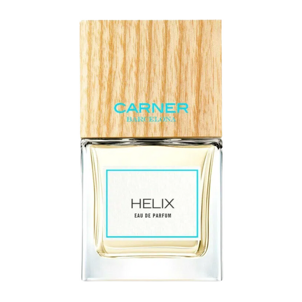 A bottle of Helix Carner Barcelona perfume with a clear glass body and a wooden cap, labeled with the brand and product name.