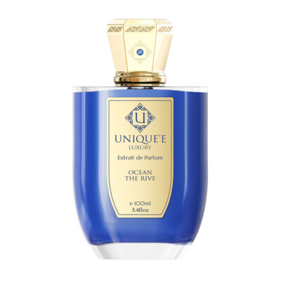 A blue bottle of 'Unique't Luxury perfume labeled 'Ocean The Rive' with a gold-colored cap.