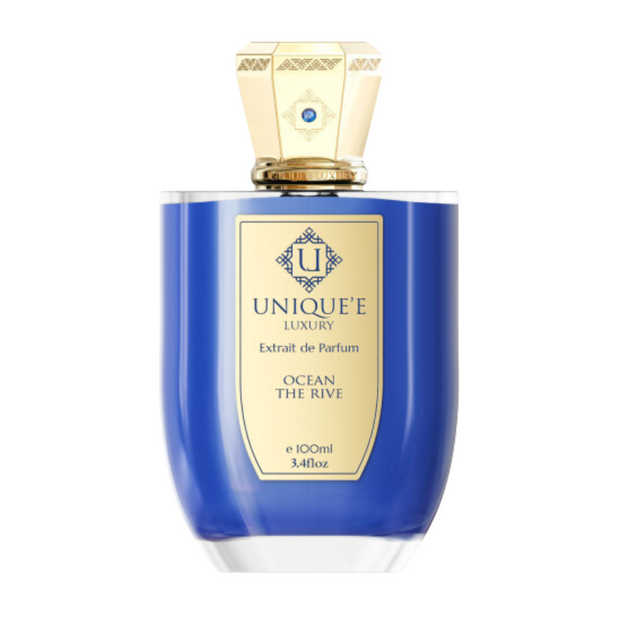 A blue bottle of 'Unique't Luxury perfume labeled 'Ocean The Rive' with a gold-colored cap.