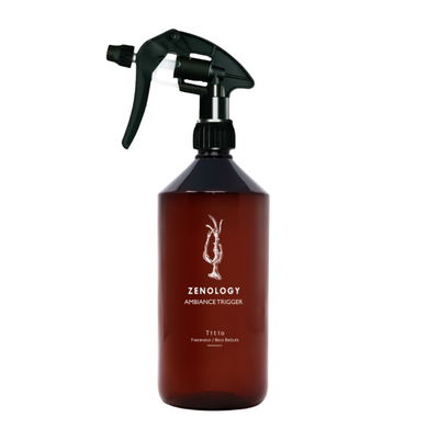 ROOM SPRAY TITIO A brown glass bottle with a black spray nozzle, labeled 'ZENOLOGY AMBROSIA TRIGGER', containing a room spray.