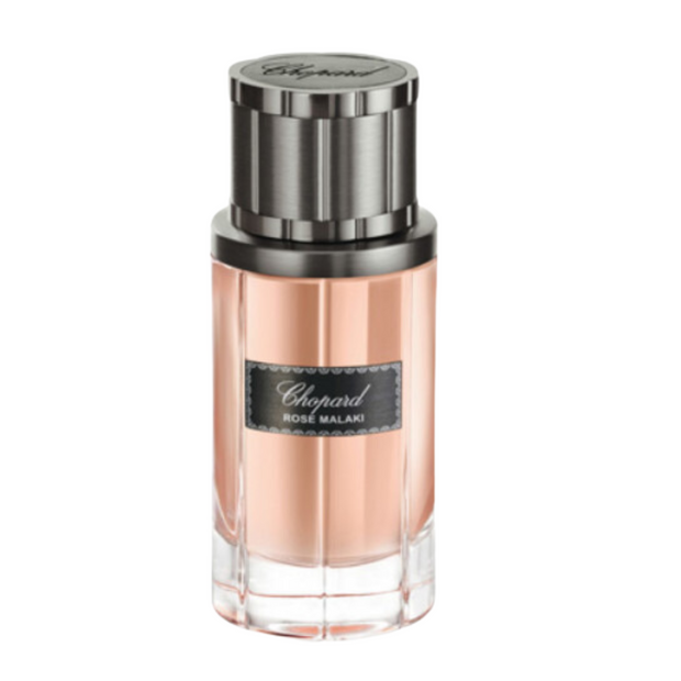 A bottle of Rose Malaki Chopard perfume with a pink hue and a metallic cap.