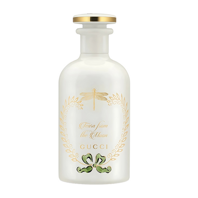 Tears From The Moonn Gucci perfume bottle with gold accents on a white background